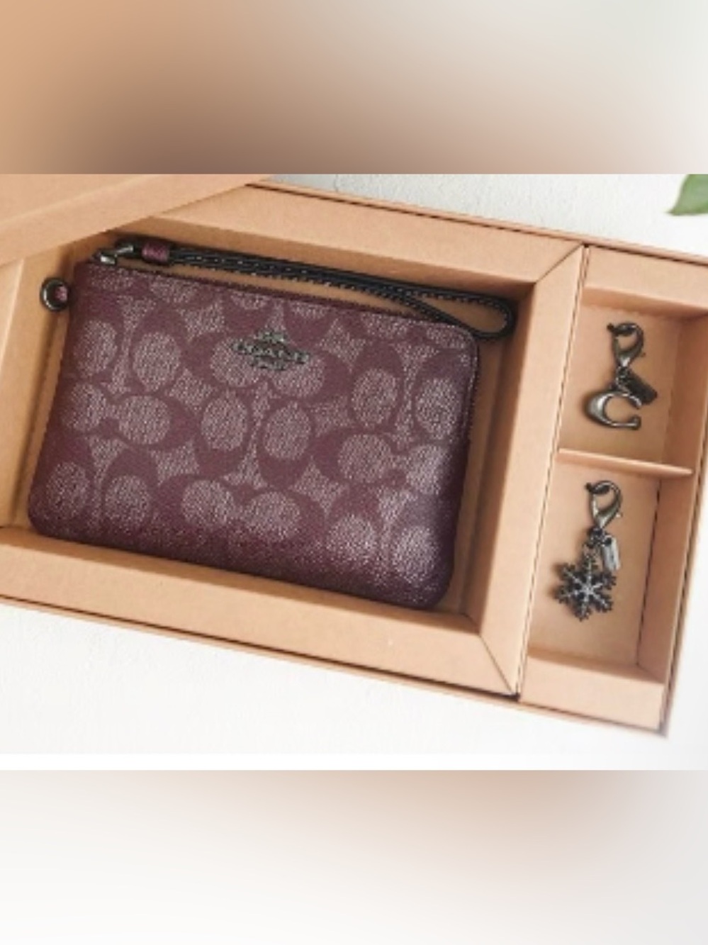 Authentic COACH wristlet with charms $128 retail